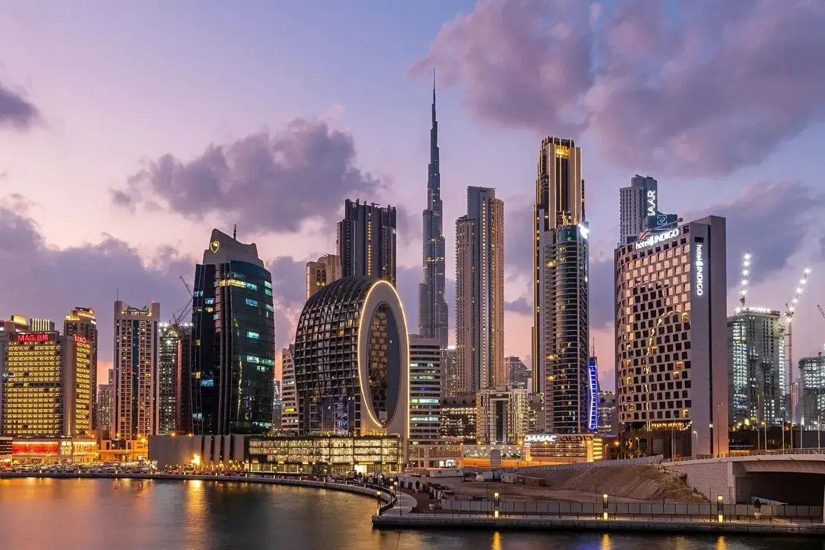 Twilight view of Business Bay and the Dubai Water Canal featuring premium hotel apartments and commercial towers, showcasing high-ROI properties by Casttio.