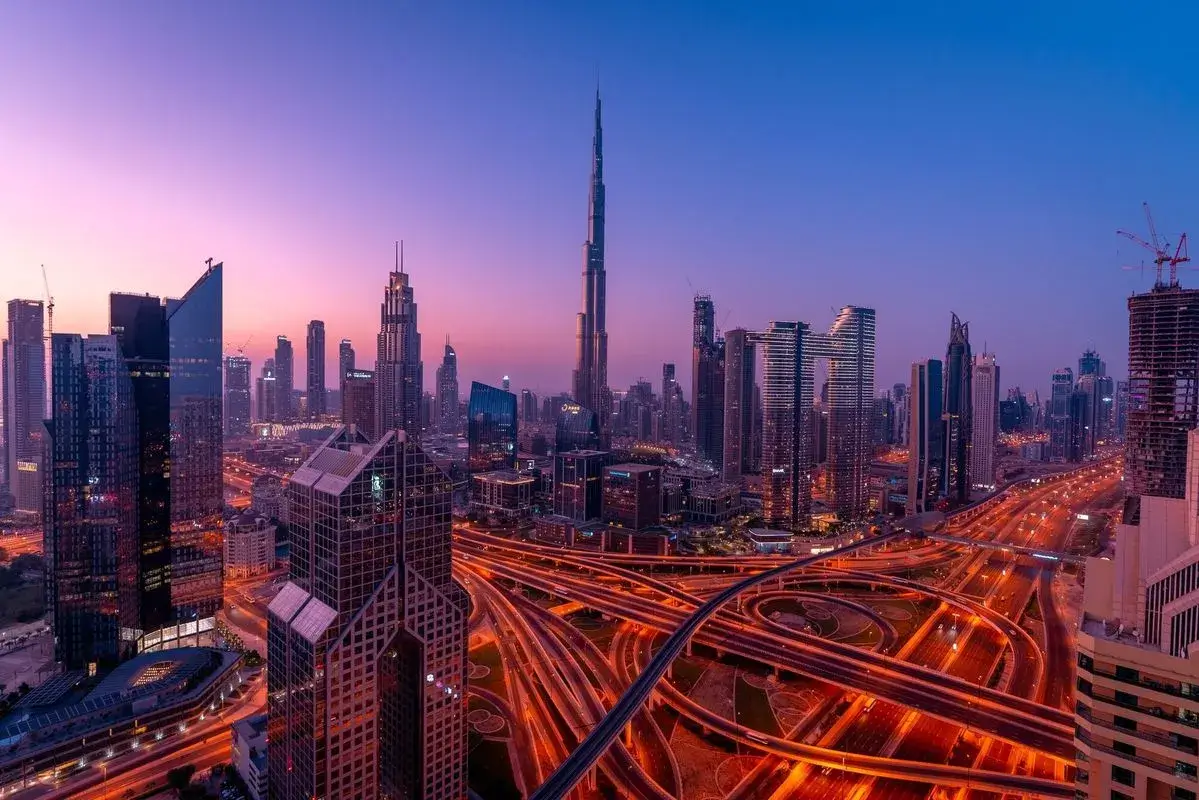 Best Off-Plan Projects Dubai : Complex Sheikh Zayed Road highway interchanges cutting through Downtown Dubai skyscrapers, symbolizing the city's highly liquid commercial real estate market.