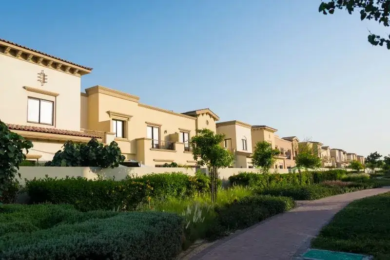 Row of modern family townhouses with beautifully landscaped pedestrian pathways in a serene Dubai gated community by Casttio