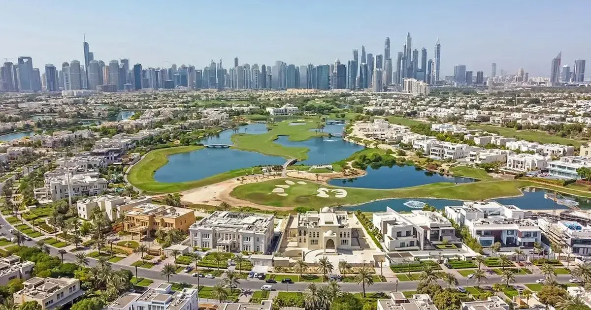 Premium luxury villas integrated into a lush championship golf course and lakes with the Dubai Marina skyline in the distance, by Casttio.