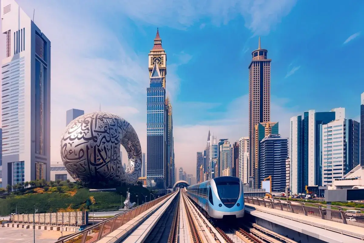 Dubai Metro train gliding past the iconic Museum of the Future, symbolizing smart city infrastructure and well-connected real estate by Casttio.