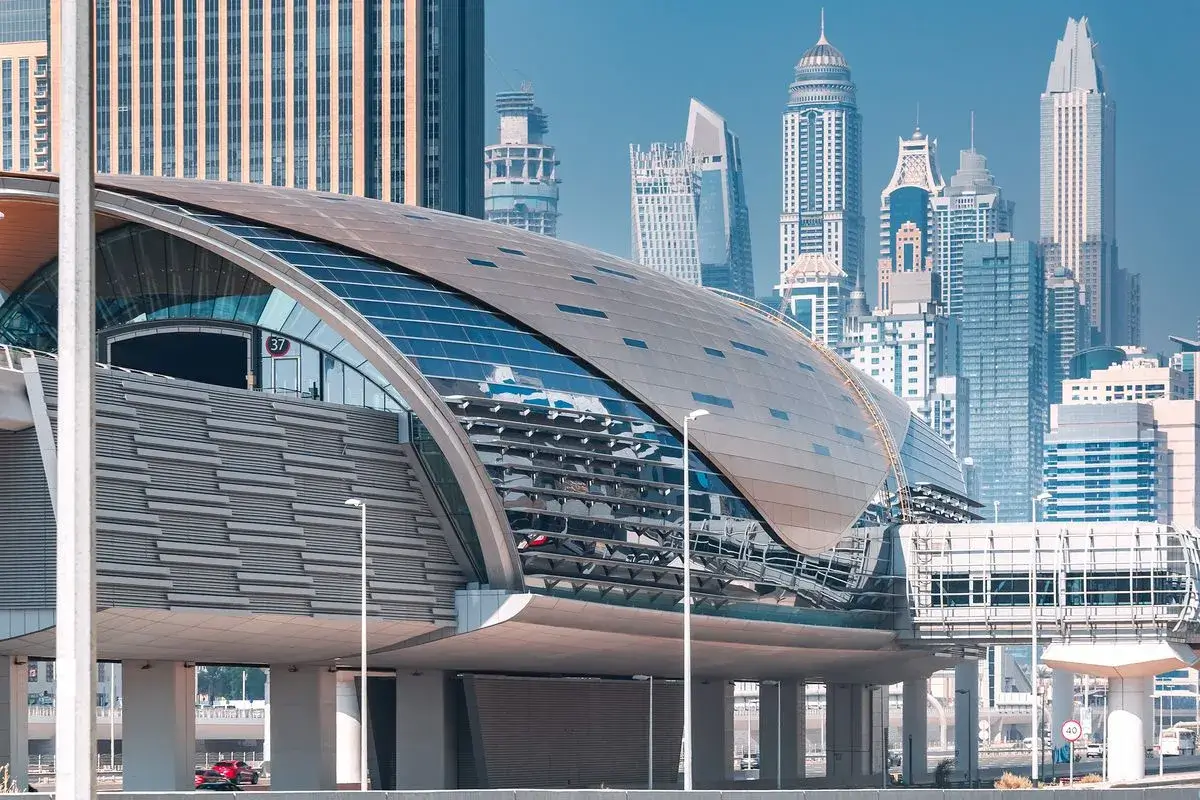 Dubai Metro Blue Line Impact : Modern exterior of a Dubai Metro station with luxury skyscrapers in the background, representing highly accessible and walkable real estate by Casttio.