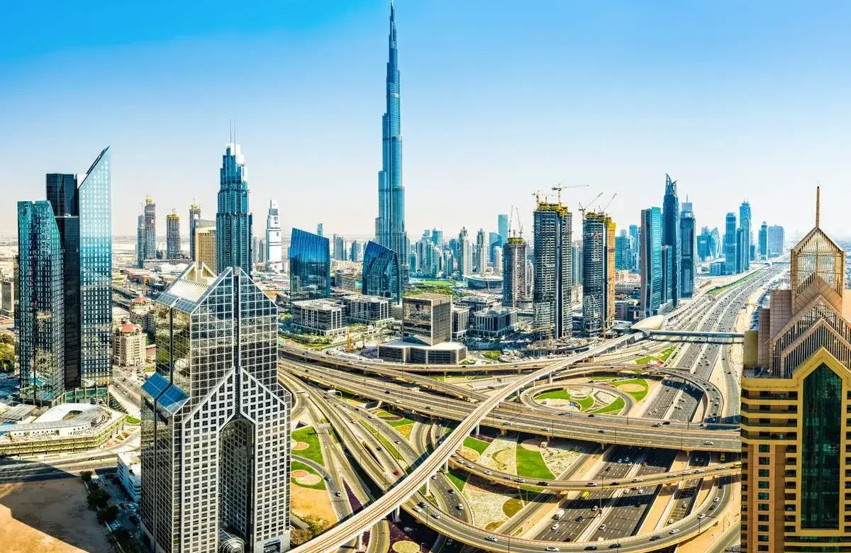 Futuristic Dubai skyline with flying vehicles and the Burj Khalifa, illustrating the 2026 real estate market forecast by Casttio Properties.