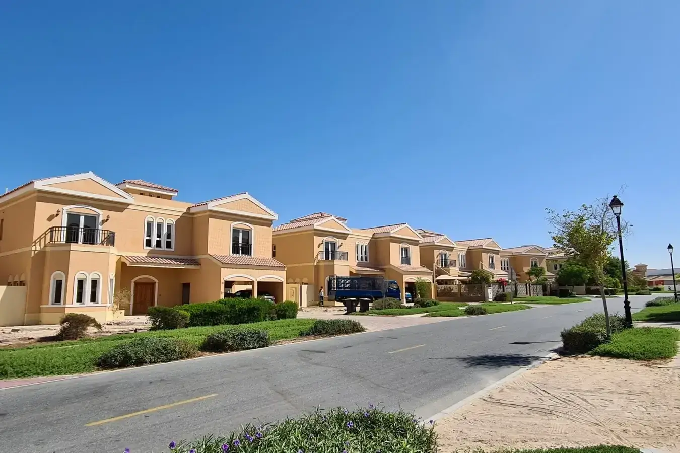Al Rowaiyah First Infrastructure: Street view of spacious family villas in a peaceful Dubai gated community, showcasing secure suburban living by Casttio Properties.